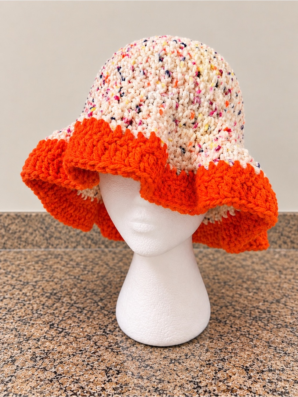 Speckled bucket hat with orange trim